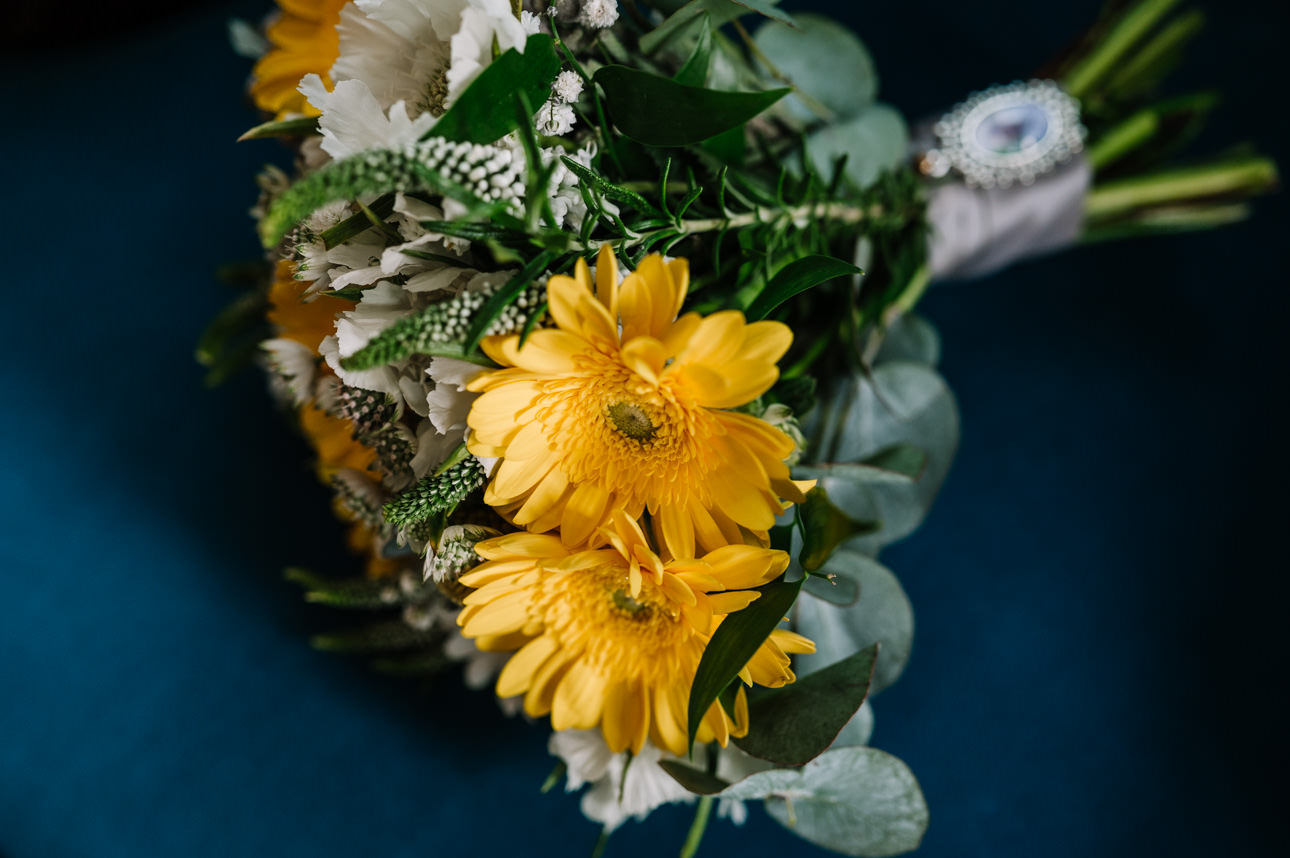 SUMMER WEDDING AT THE SWAN HOTEL BIBURY 9 Bright yellow sunflower bridal bouquet for a vibrant summer wedding at the Swan Hotel Bibury.