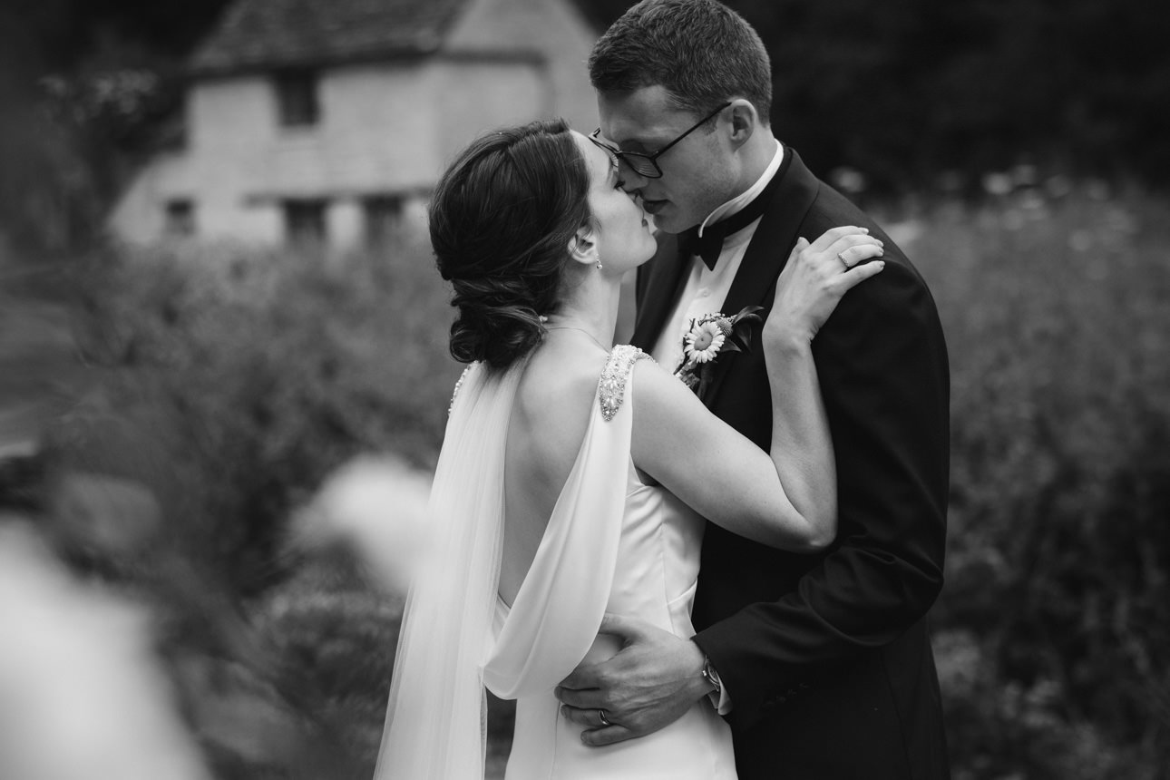 SUMMER WEDDING AT THE SWAN HOTEL BIBURY 37 Intimate and romantic black and white embrace of the bride and groom at their summer wedding at the Swan Hotel Bibury.