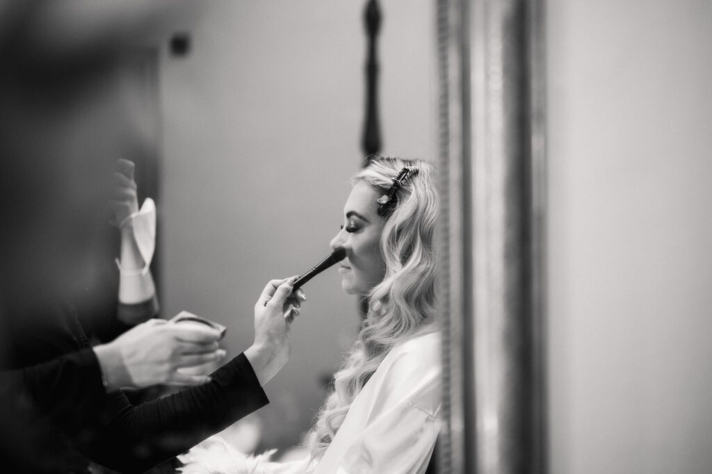 A CHRISTMAS WINTER WEDDING AT THE KINGS HEAD 15 Bride having her makeup applied during bridal preparations