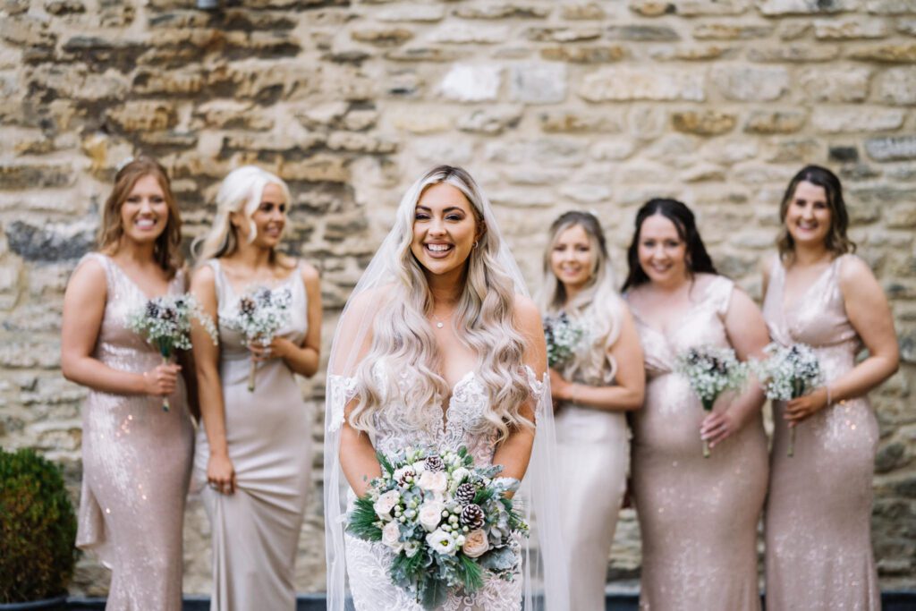 A CHRISTMAS WINTER WEDDING AT THE KINGS HEAD 27 Bride with her bridesmaids outside the Kings Head Hotel after the wedding ceremony