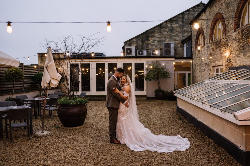 A CHRISTMAS WINTER WEDDING AT THE KINGS HEAD 28 Bride and groom standing together in the courtyard at the Kings Head Hotel