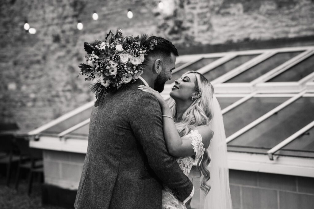 A CHRISTMAS WINTER WEDDING AT THE KINGS HEAD 29 Bride and groom embracing outside the Kings Head Hotel during their winter wedding