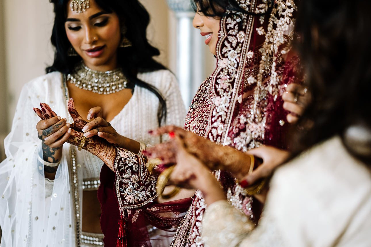 Indian wedding showing henna tattoos on the bride's hands