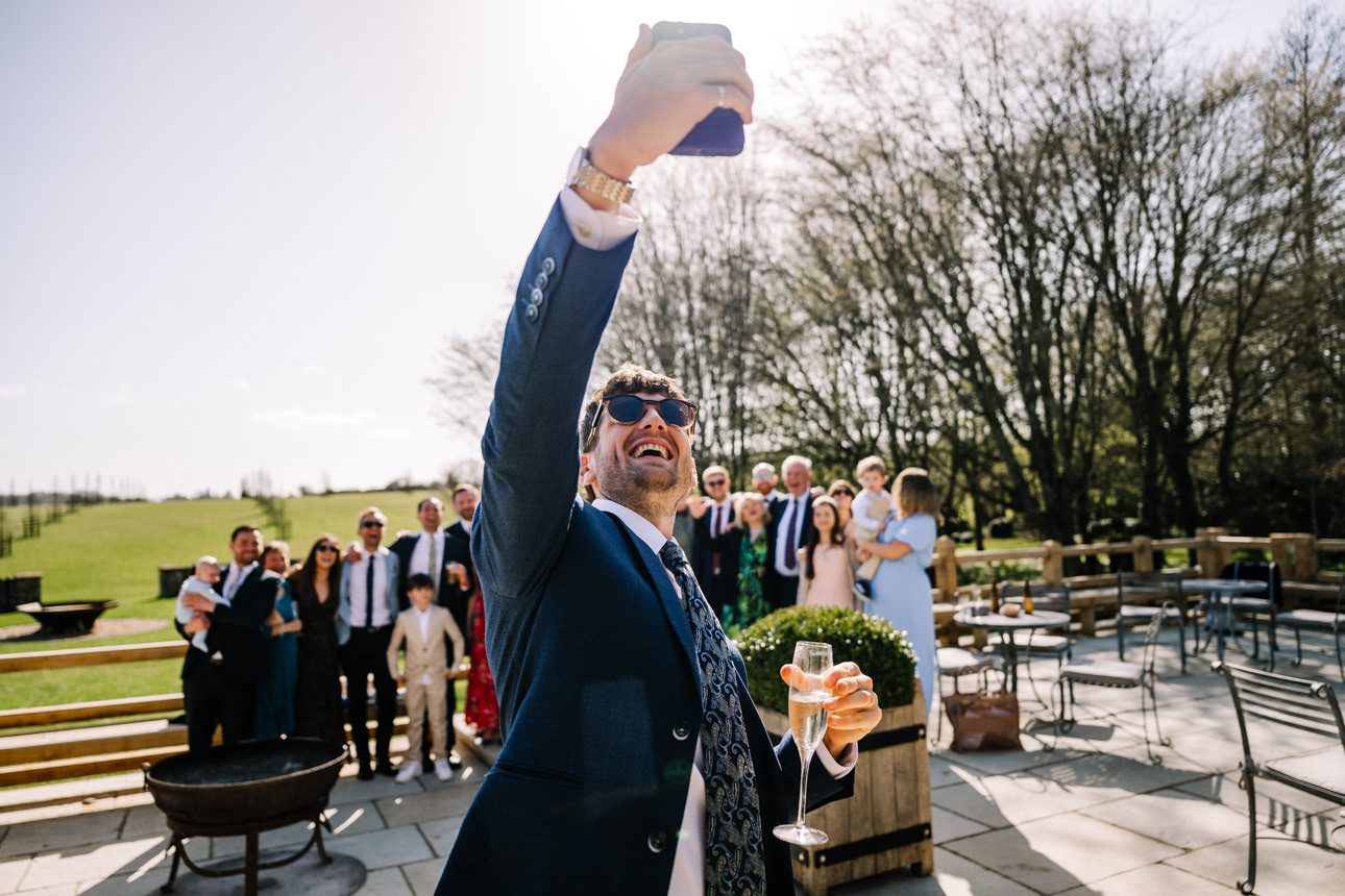 Man taking selfie at celebration.