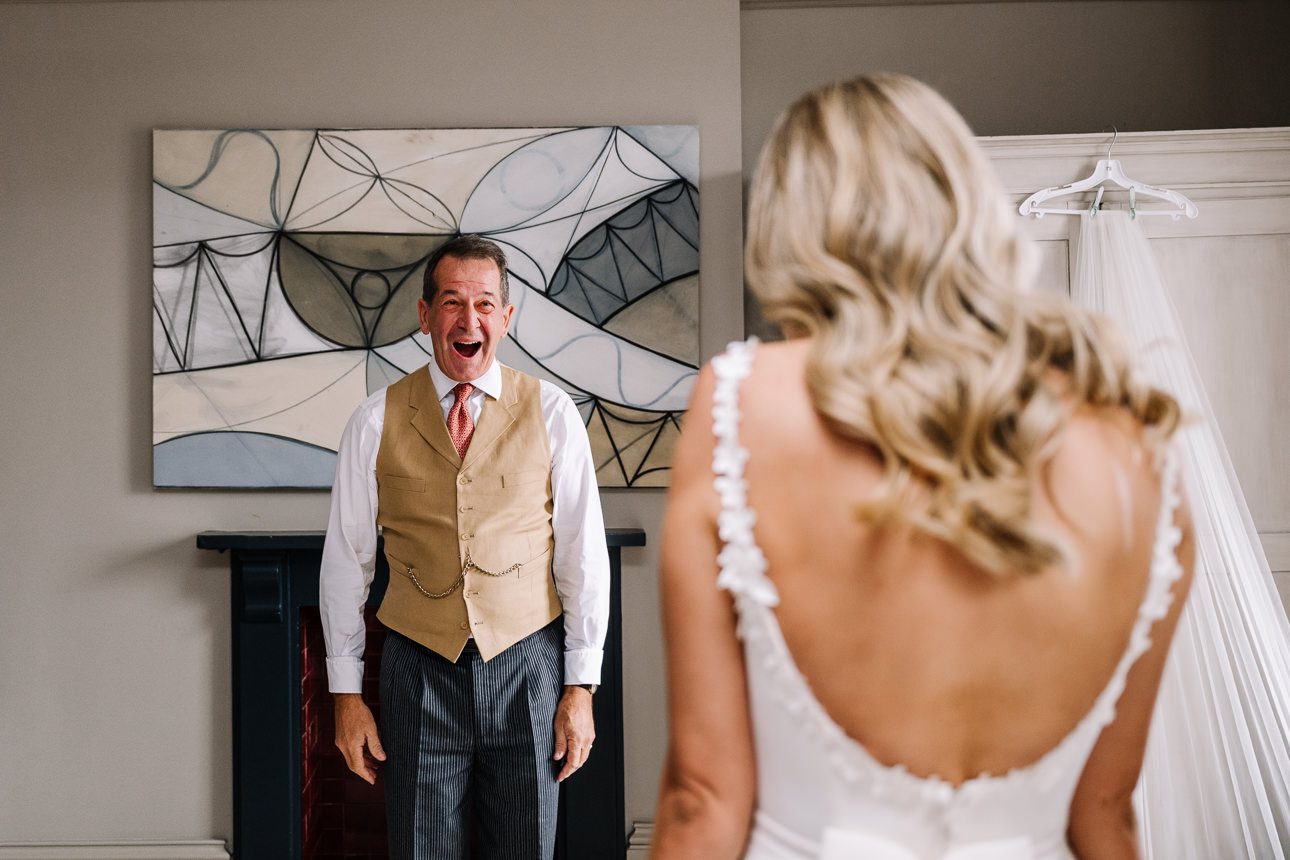 father of the bride seeing his daughter in her wedding dress