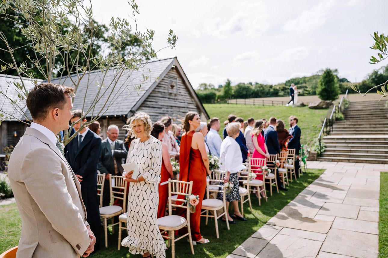 Bride arriving at the aisle for summer wedding at Upcote Barn.