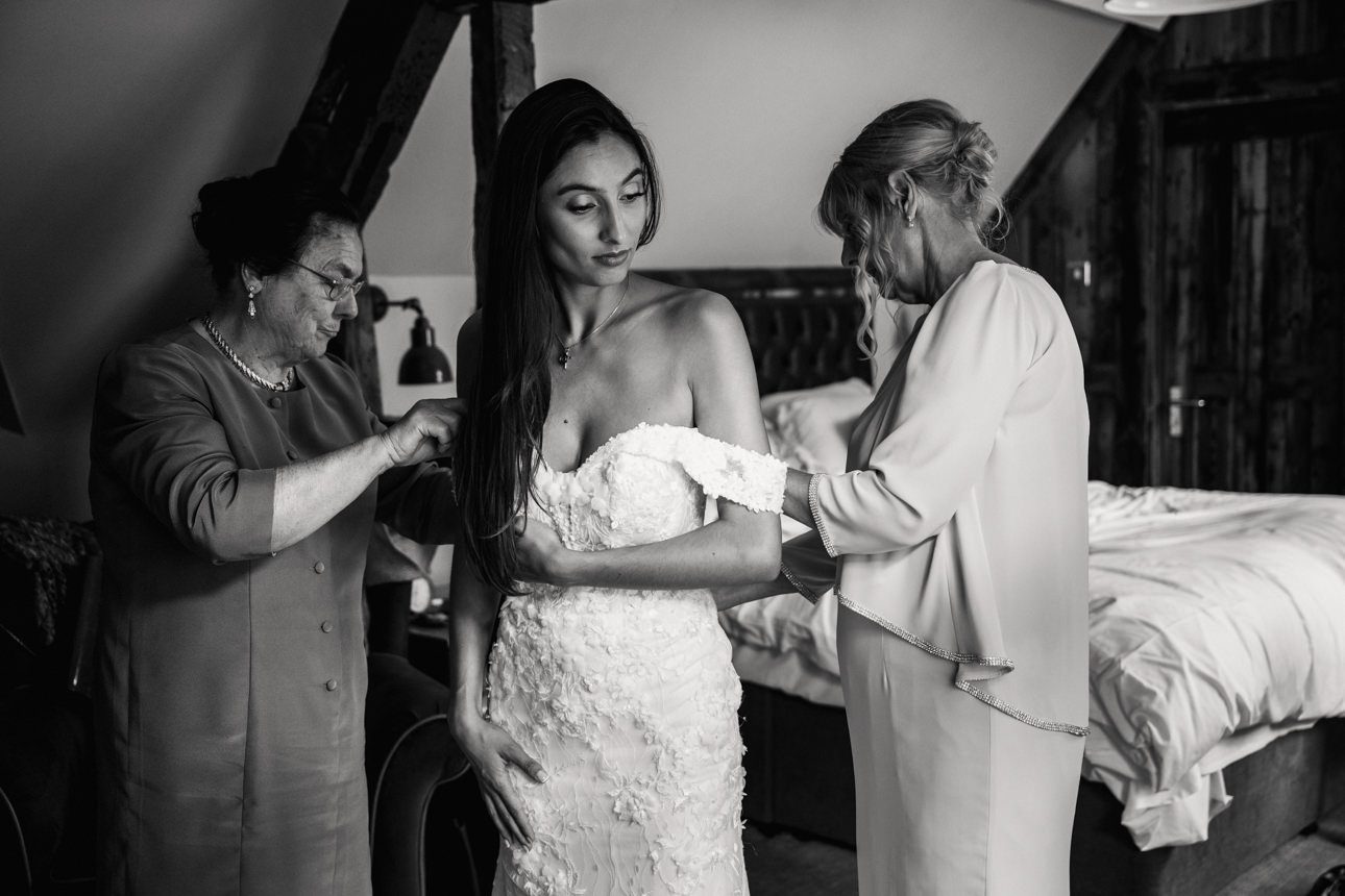 bride getting into her wedding dress