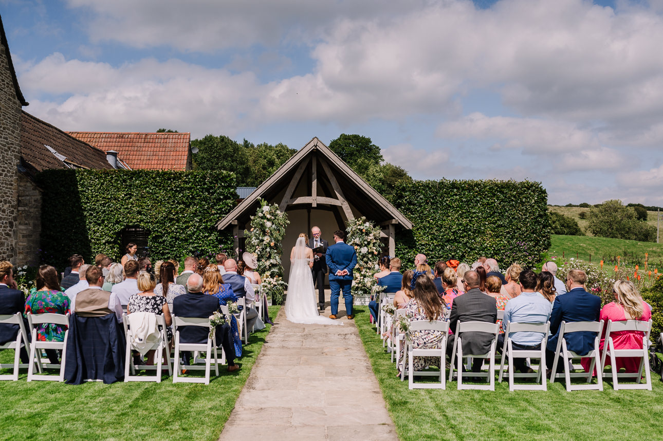 Kingscote Barn outdoor wedding ceremony