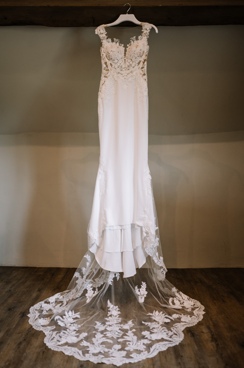 LAPSTONE BARN WEDDING PHOTOGRAPHER 23 Detailed shot of a classic white lace wedding dress train on display at Lapstone Barn.