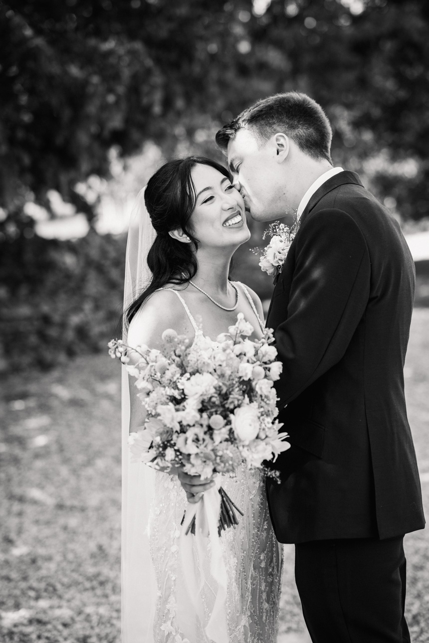 LAPSTONE BARN WEDDING PHOTOGRAPHER 42 Black and white documentary wedding photography of a newlywed couple laughing together outside at Lapstone Barn.