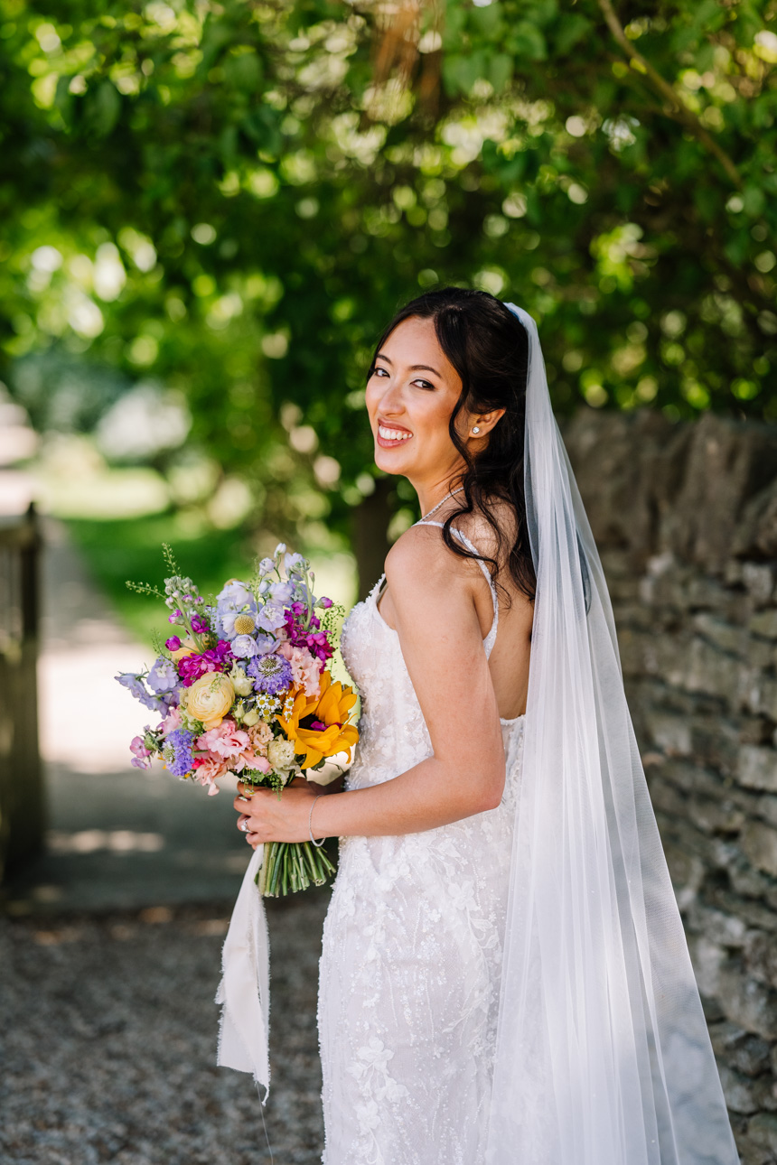 LAPSTONE BARN WEDDING PHOTOGRAPHER 43 Elegant portrait of a bride in a classic white veil and lace dress posing outdoors at Lapstone Barn.