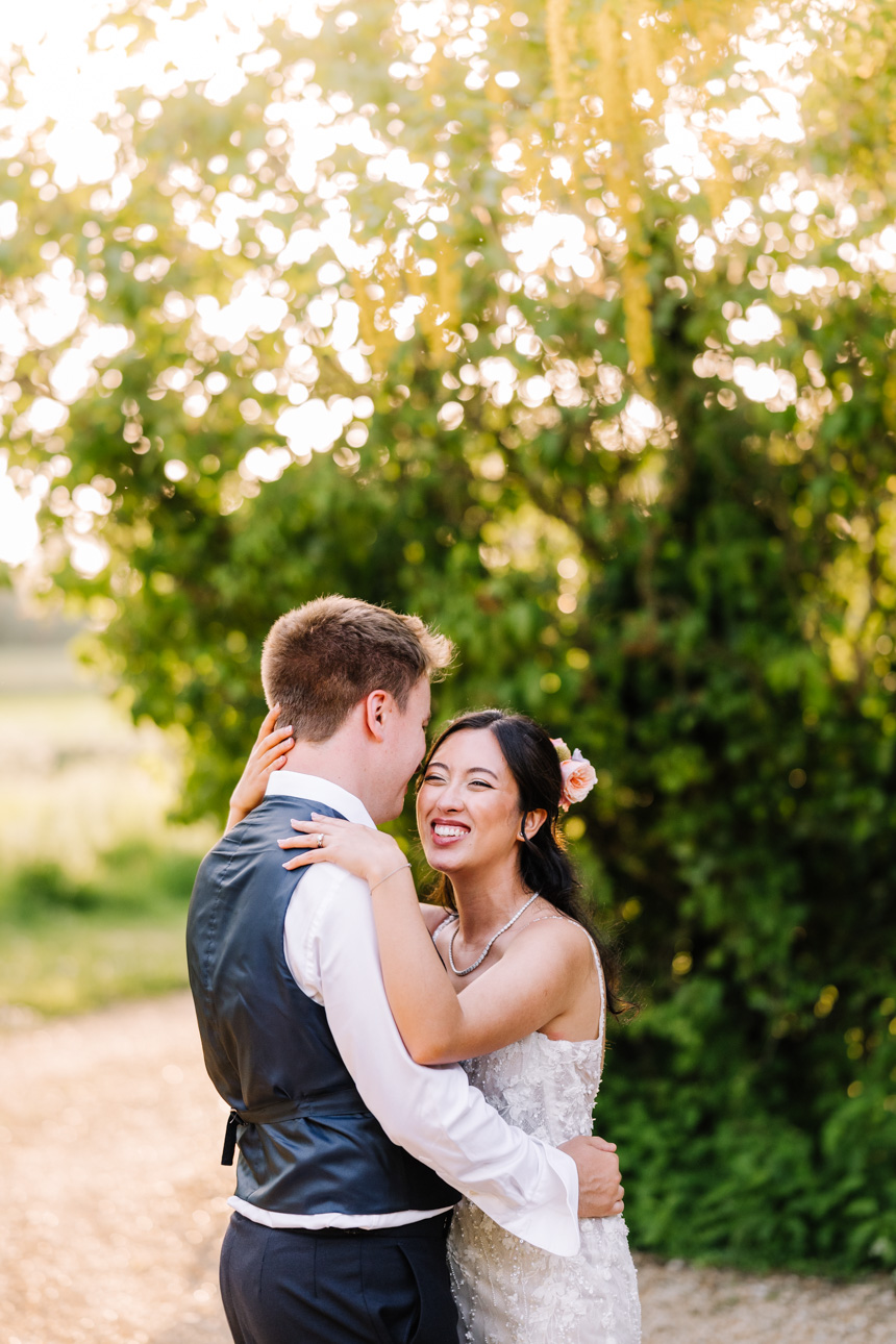 LAPSTONE BARN WEDDING PHOTOGRAPHER 66 Romantic golden hour portrait of a bride and groom embracing in the outdoor gardens at Lapstone Barn.