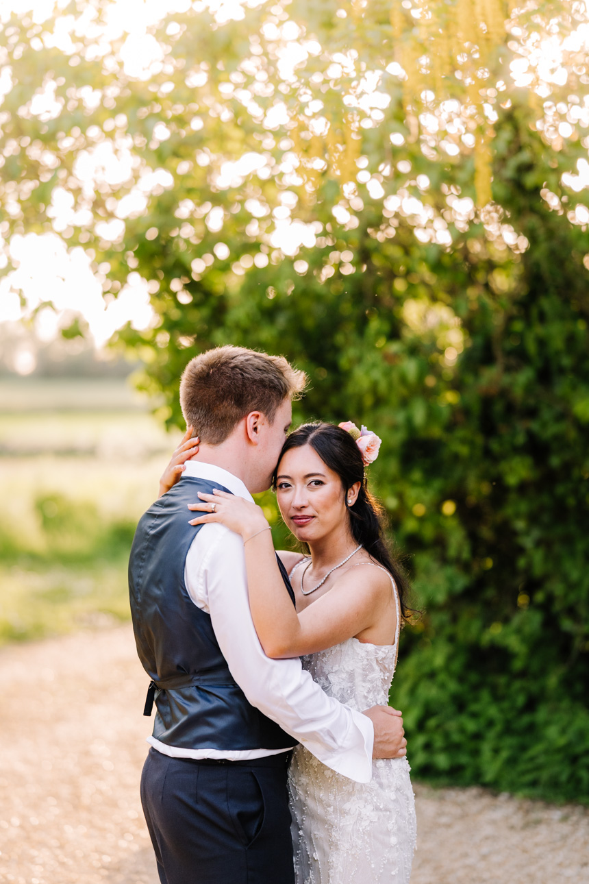 LAPSTONE BARN WEDDING PHOTOGRAPHER 67 Romantic golden hour portrait of a bride and groom embracing in the outdoor gardens at Lapstone Barn.