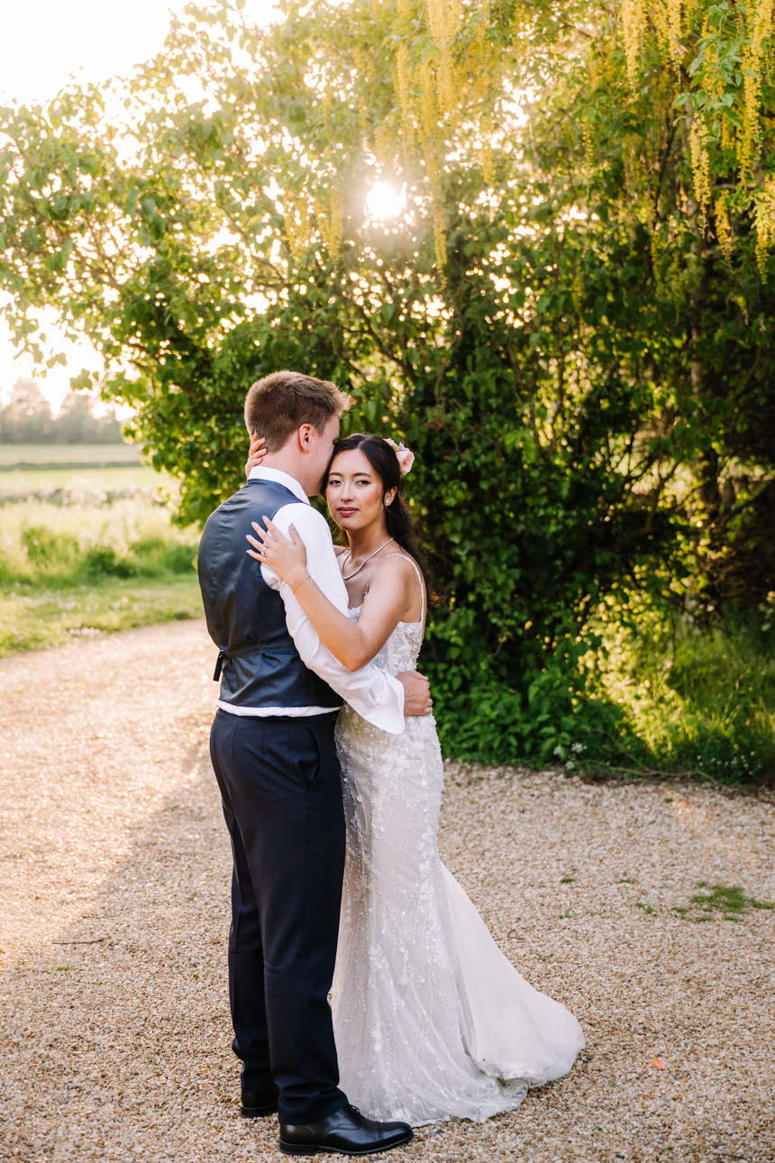 LAPSTONE BARN WEDDING PHOTOGRAPHER 46 Groom looking down affectionately at his bride during a sunny outdoor couples session at Lapstone Barn.