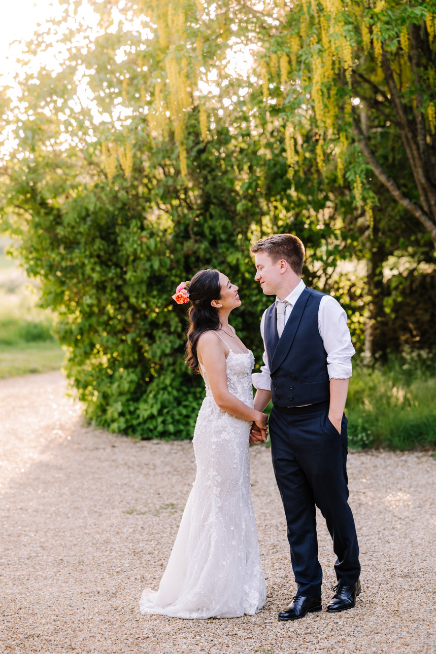 LAPSTONE BARN WEDDING PHOTOGRAPHER 69 Romantic golden hour portrait of a bride and groom embracing in the outdoor gardens at Lapstone Barn.