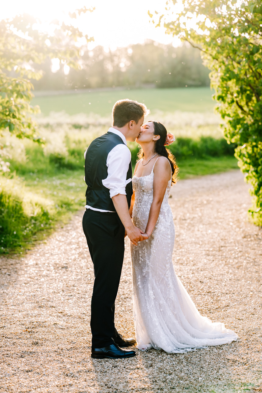 LAPSTONE BARN WEDDING PHOTOGRAPHER 49 Romantic portrait of a bride and groom walking together along a scenic lane at a Lapstone Barn wedding.