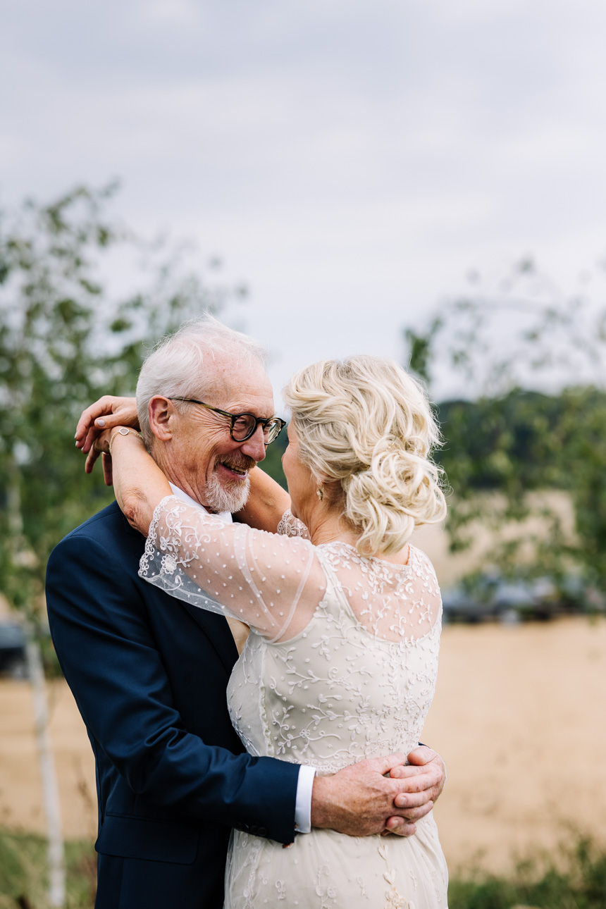 LAPSTONE BARN WEDDING PHOTOGRAPHER 55 An older bride and groom sharing a sweet, intimate hug during their wedding day at Lapstone Barn.