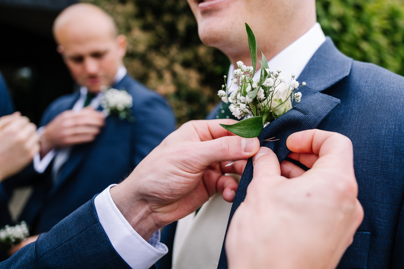 FLORA AND WILLIAM PRIMROSE HILL FARM SPRING WEDDING 19 Groom having his button hole put on at Primrose Hill Farm