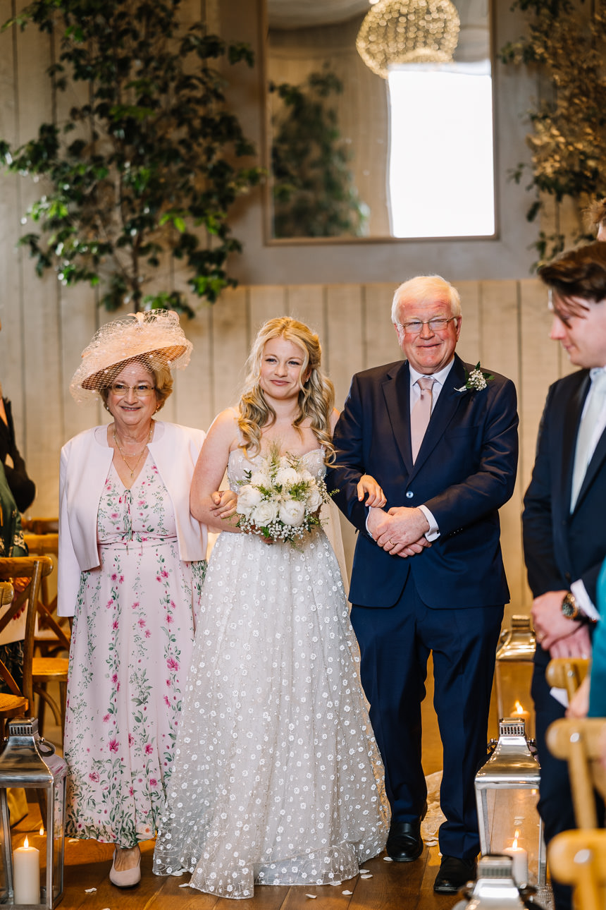 FLORA AND WILLIAM PRIMROSE HILL FARM SPRING WEDDING 21 Bride walking into her wedding ceremony with her father