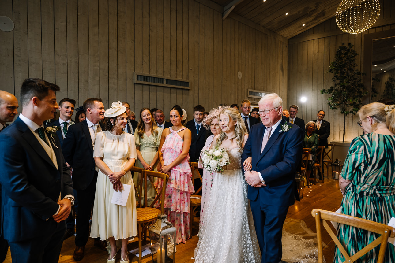 FLORA AND WILLIAM PRIMROSE HILL FARM SPRING WEDDING 22 Bride and her father walking down the aisle during a spring wedding at Primrose Hill Farm