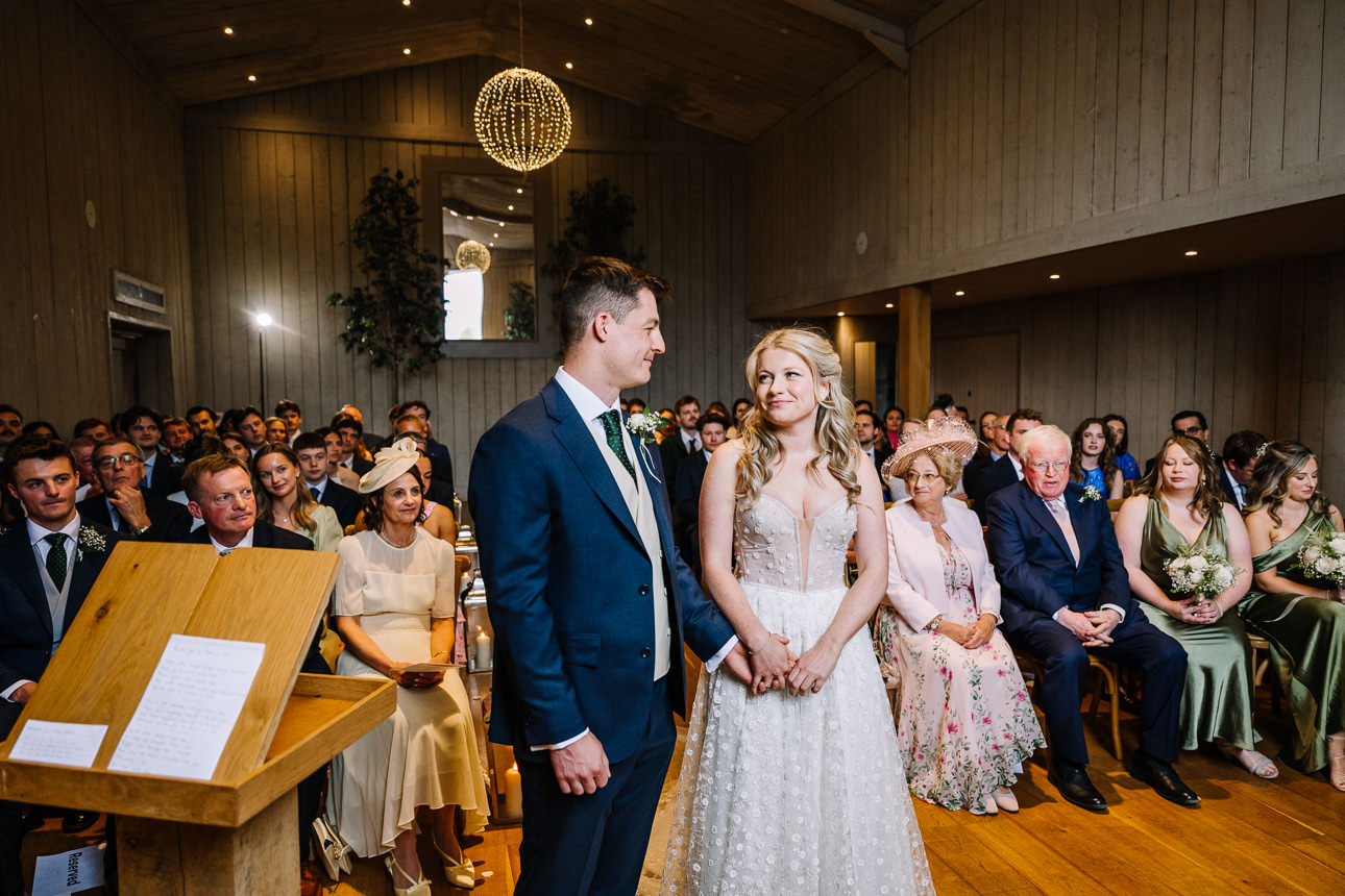 FLORA AND WILLIAM PRIMROSE HILL FARM SPRING WEDDING 26 Newly married couple standing together at their Primrose Hill Farm spring wedding ceremony