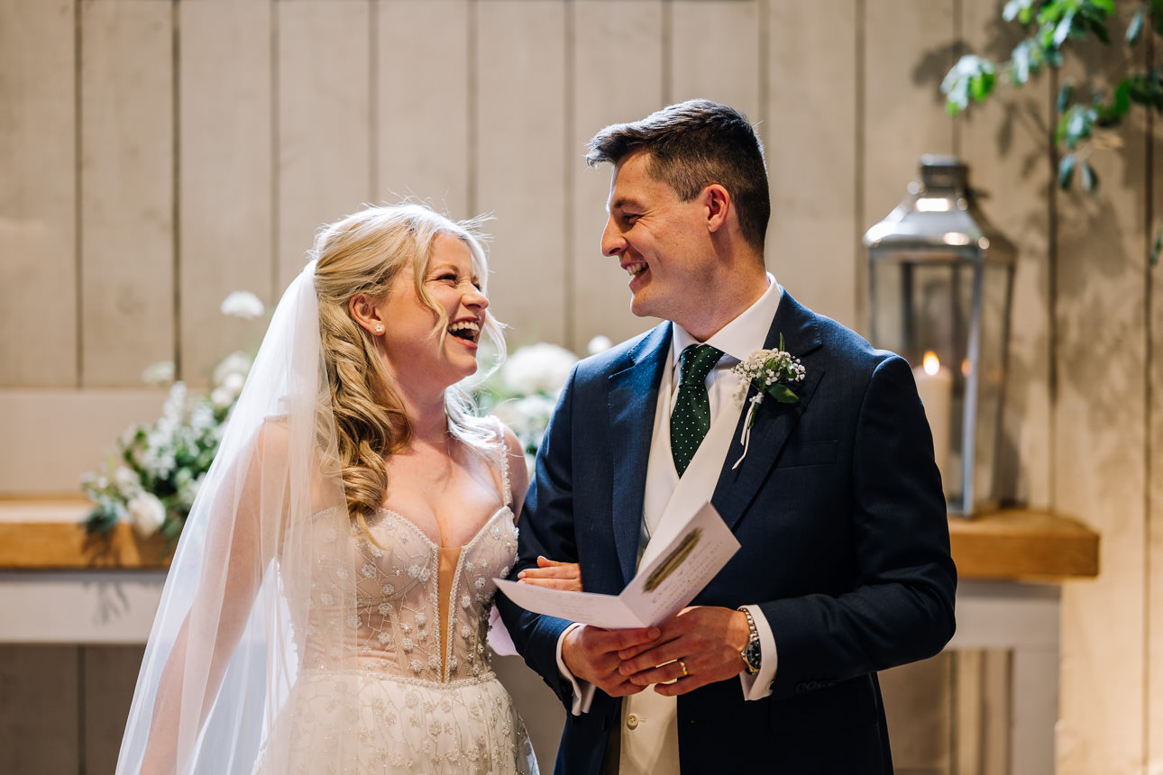 FLORA AND WILLIAM PRIMROSE HILL FARM SPRING WEDDING 30 Newly married bride and groom smiling together inside Primrose Hill Farm