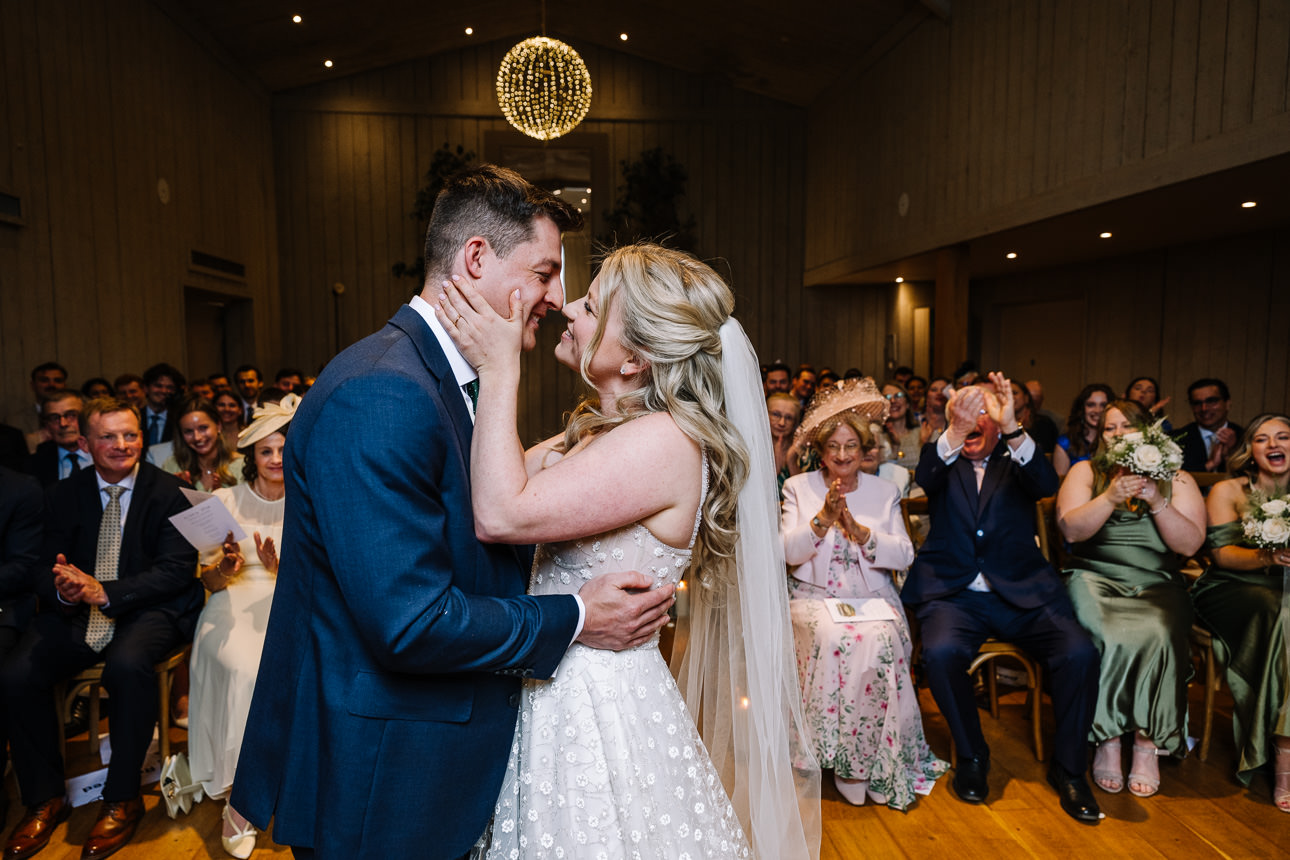 FLORA AND WILLIAM PRIMROSE HILL FARM SPRING WEDDING 32 Bride and groom sharing a kiss during their wedding reception