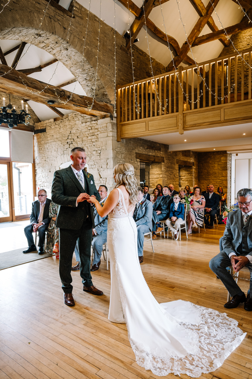 GREAT TYTHE BARN WEDDING PHOTOGRAPHER 117 Bride and Groom ring exchange at The Great Tythe Barn.