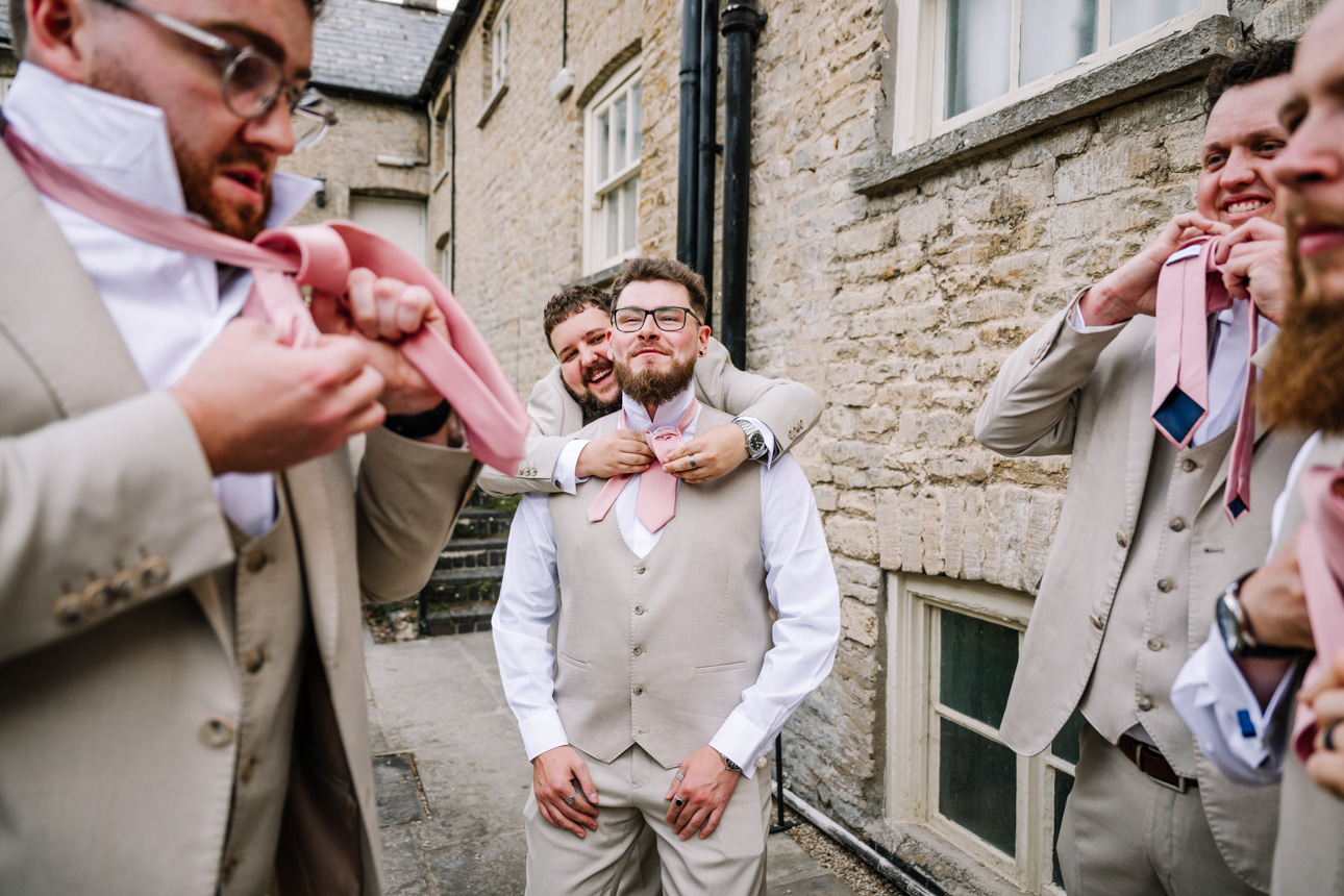 OLD GORE WEDDING PHOTOGRAPHER 20 groomsmen putting on ties Old Gore wedding