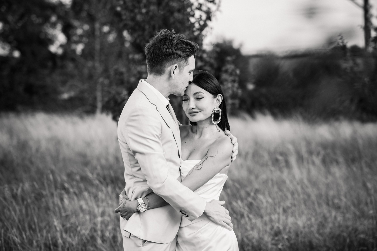 OXLEAZE BARN WEDDING PHOTOGRAPHER 101 Black and white photo of couple embracing at Oxleaze Barn
