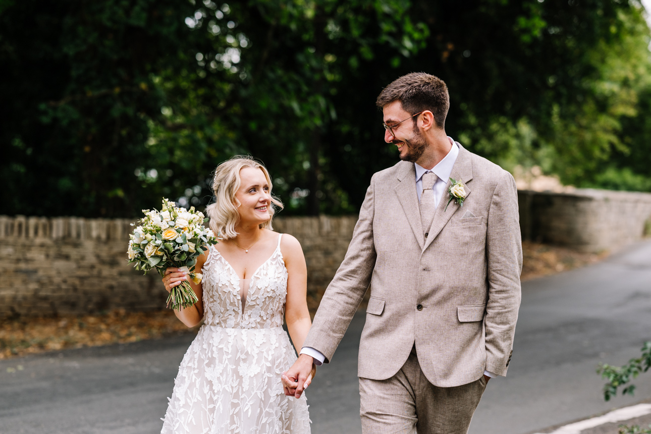 REVIEWS 68 Married couple walking hand in hand along pretty church lane